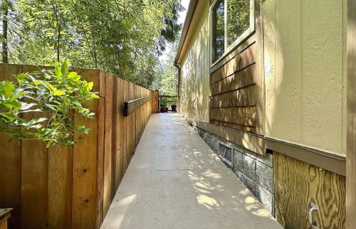 A walkway leading to a home with a wooden fence.