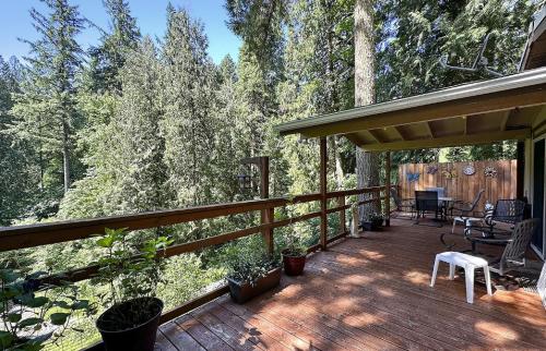 A wooden deck overlooking a wooded area.