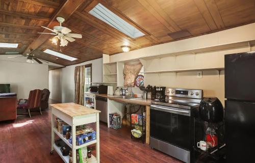 A kitchen with wood floors and a ceiling fan.