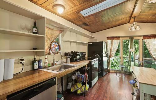 A kitchen in a tiny house with wood floors.