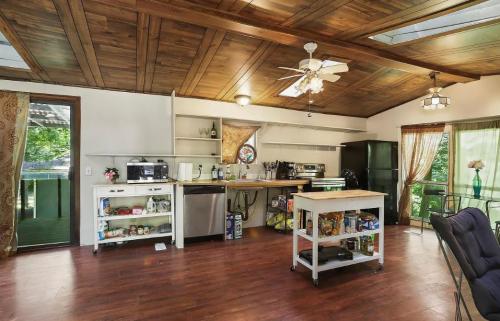 A kitchen with wood floors and a ceiling fan.