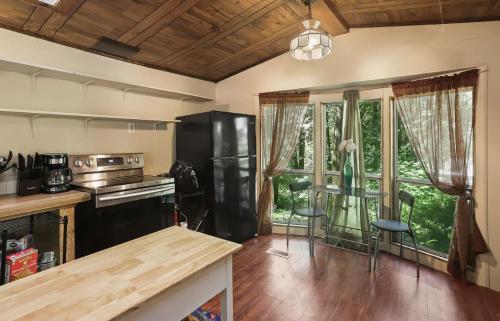 A kitchen with wood ceilings and a refrigerator.