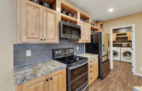 A kitchen with wood cabinets and a washer and dryer.