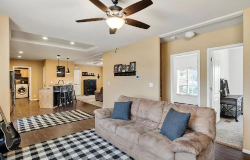 A living room with a ceiling fan and a couch.