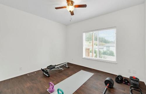 A gym room with a fan and exercise equipment.