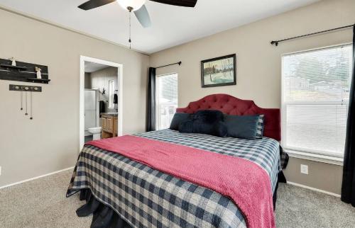 A bedroom with a bed and a ceiling fan.