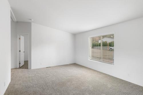 Empty room with white walls and carpet.