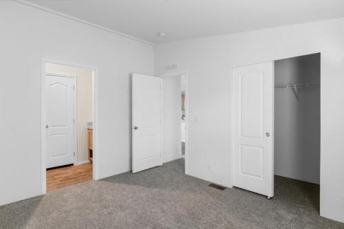 A room with a closet and a door.